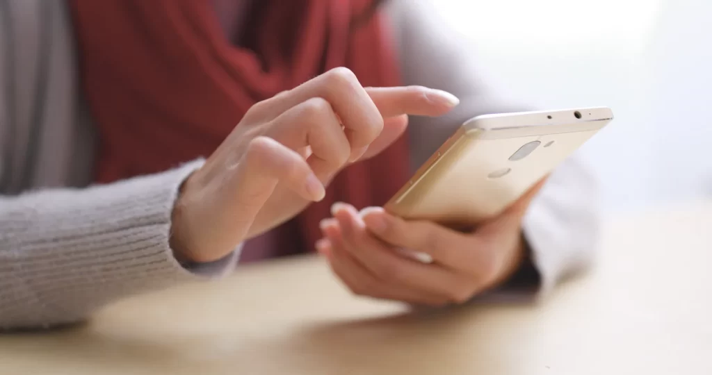 hands using smart phone for communication indoors utc