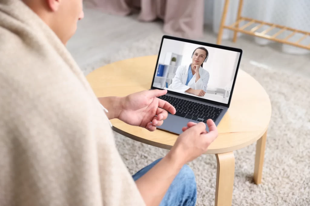 man having online consultation with female doctor utc